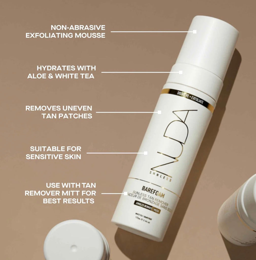 White exfoliating mousse bottle with text on a beige background