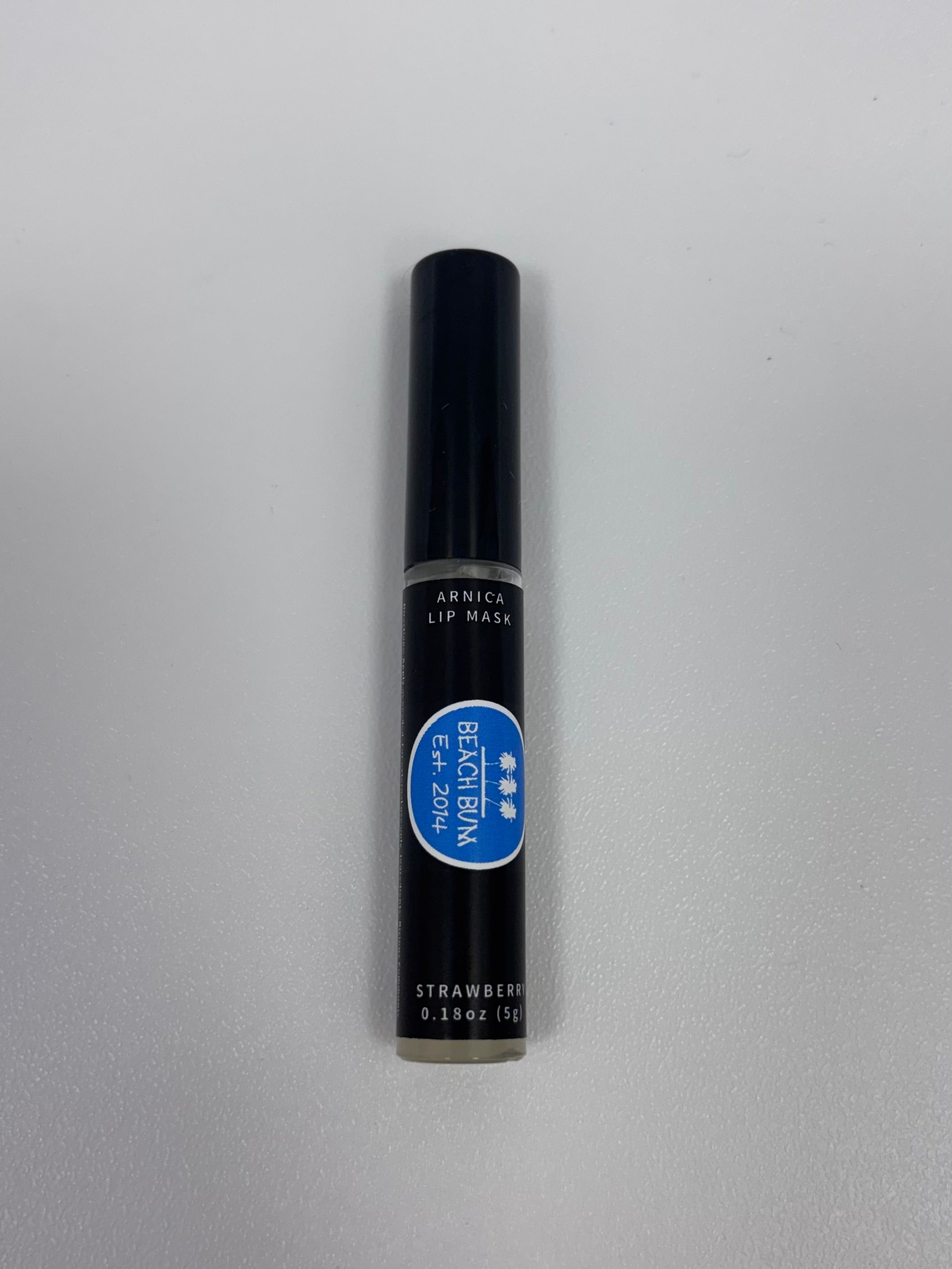 Black lip mask container with blue label on a gray background